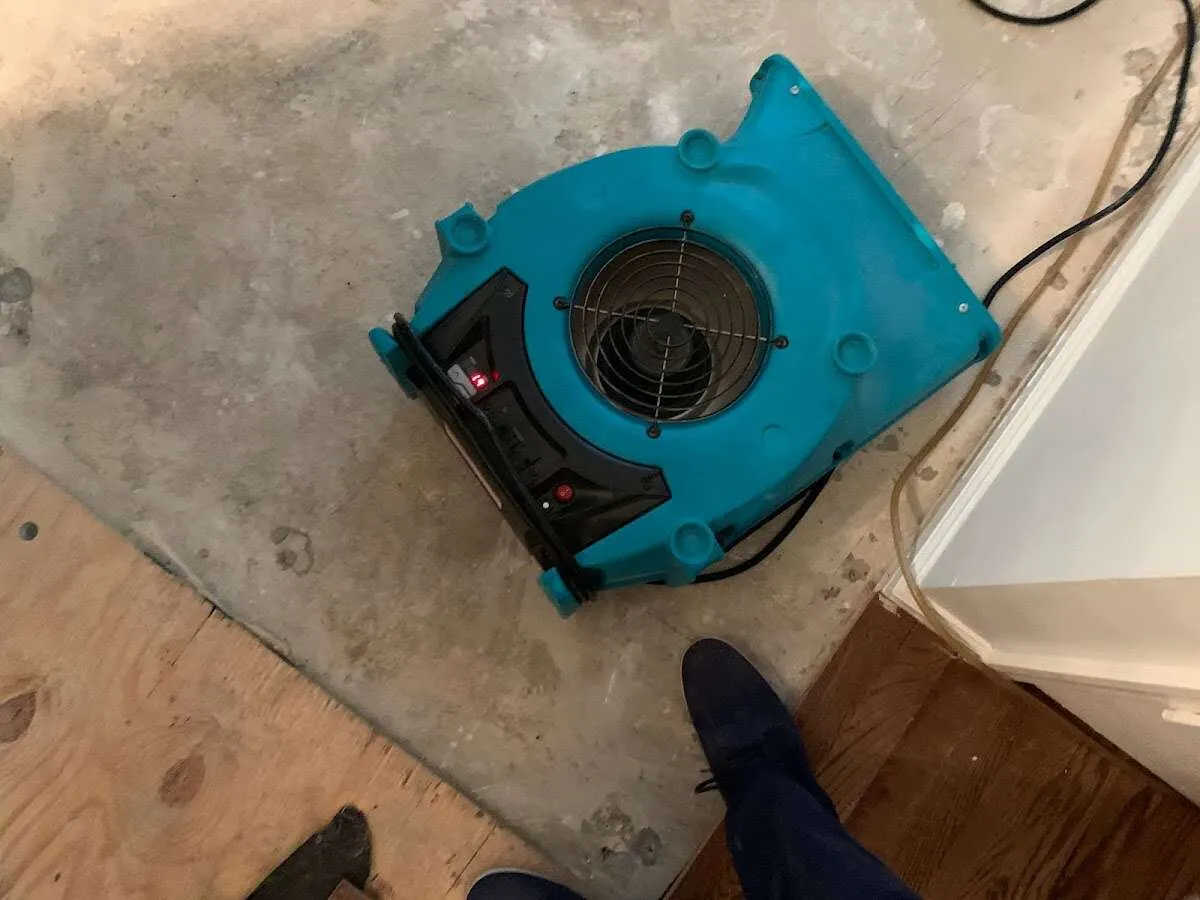 Air mover drying subfloor during Leak Detection & Repair in Hibbing